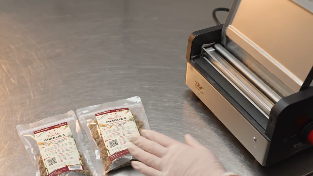 A PupEats daily pack being filled and sealed by hand